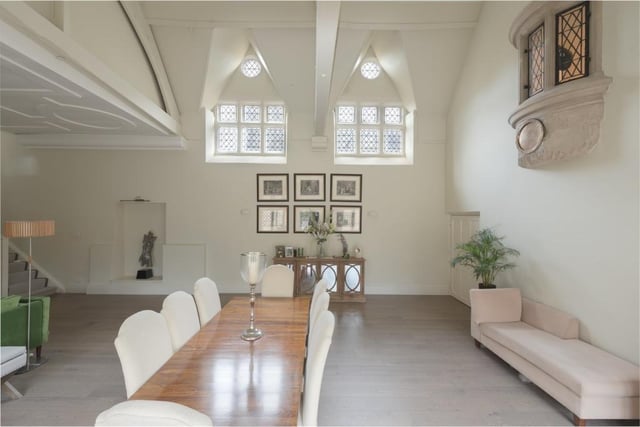 The central living space is breathtaking, with beautiful beams, arches, niches, stone mullion windows and striking, lofty, curved window from where the chef used to watch over what was once the kitchen for the main house, and later the school refectory