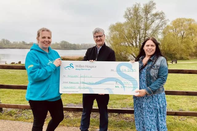 Milton Keynes city councillor Mick Legg presents the cheque for £12,500 to Willen Hospice's community and events fundraising manager Nikki Poole, right, and her colleague Emily Penwright
