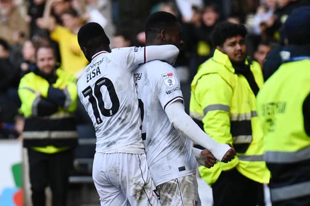 Mo Eisa joins Jonathan Leko in celebrating the latter's strike against Morecambe on Saturday as MK Dons moved up to 19th in League One