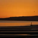 The sun sets over Camber Sands.