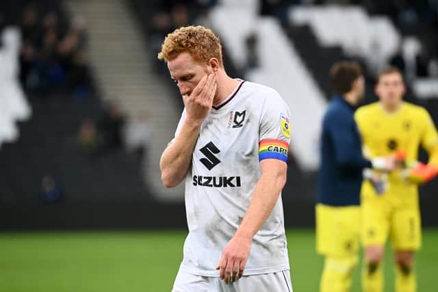 Dean Lewington leaves the field after MK Dons' defeat to Wycombe Wanderers on Saturday. The loss sent Dons to the bottom of the league