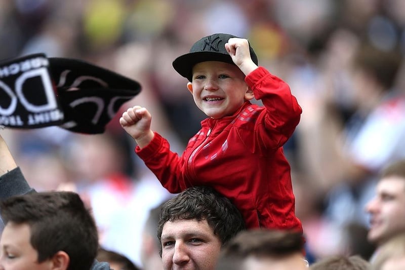 A young MK Dons fan celebrates as his team are promoted to the Sky Bet Championship on May 3, 2015.