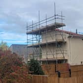 The house is surrounded by scaffolding