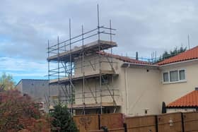 The house is surrounded by scaffolding