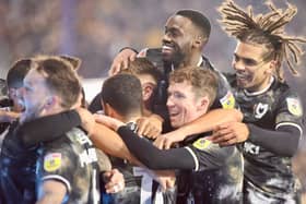 MK Dons celebrate Jack Tucker's goal against Portsmouth which led to Dean Lewington's first win in charge of the side