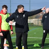 Dons boss Mark Jackson gives instructions during a much-needed spell on the training pitch for MK Dons