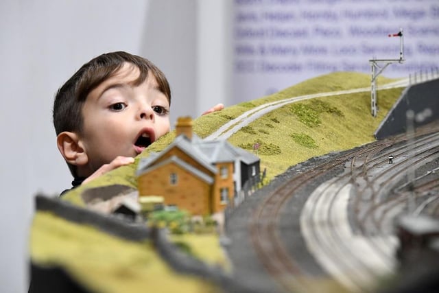 A young boy's wonder at the trains is displayed in his face