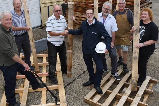 Bellway Senior Buyer Rob Morcombe and volunteers of Men in Sheds MK with donated wooden pallets