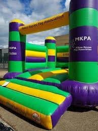 The bouncy castle is clearly marked with Milton Keynes Play Association's name