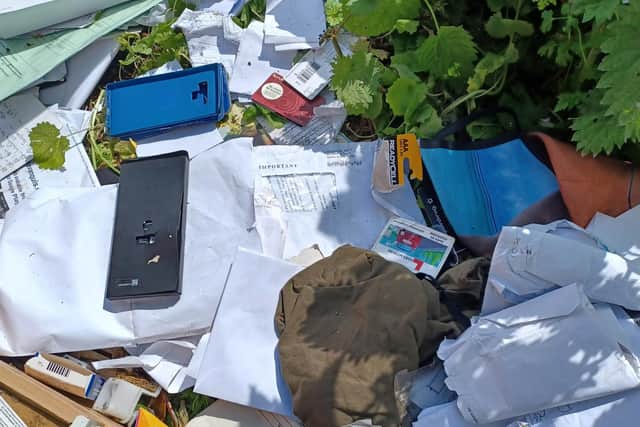 The culprit's details can be seen on personal papers among the dumped rubbish