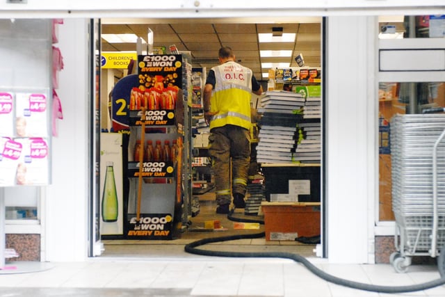These fire crews were mopping out a town centre store after storm chaos in South Shields 13 years ago.