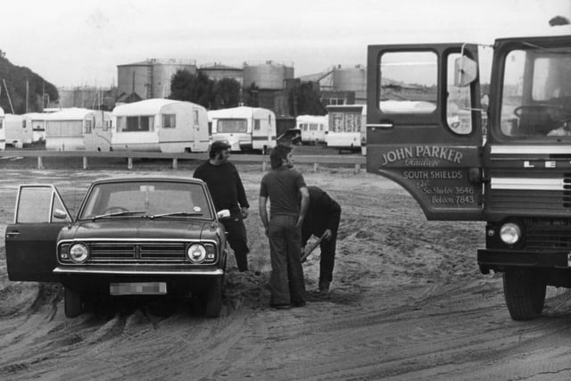 A car is dug out of the sand on the north foreshore after heavy storms 46 years ago.