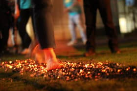 Volunteers are needed to walk barefoot through fire to raise cash for a charity in Milton Keynes