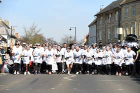 The women line up, complete with pans and pancakes, to start the famous race