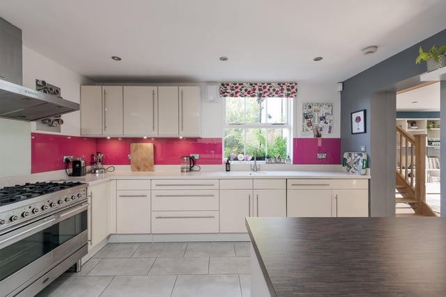 Another view of the modern re-fitted kitchen features breakfast island, range cooker with open plan living area