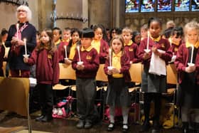Children held lit candles for the final hymn
