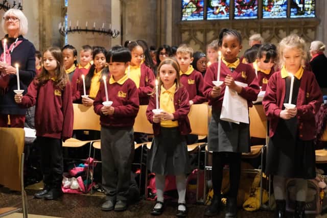 Children held lit candles for the final hymn