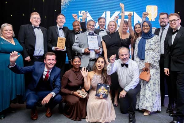 The school team receiving their award with pride