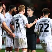 LONDON, ENGLAND - OCTOBER 25: MK Dons players surround the referee during the Sky Bet League One between Charlton Athletic and Milton Keynes Dons at The Valley on October 25, 2022 in London, England. (Photo by Alex Pantling/Getty Images)