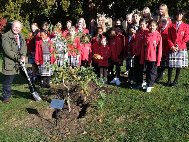 Vice Lord-Lieutenant Alexander Boswell with Prep and Senior Eco Committee students planting the tree
