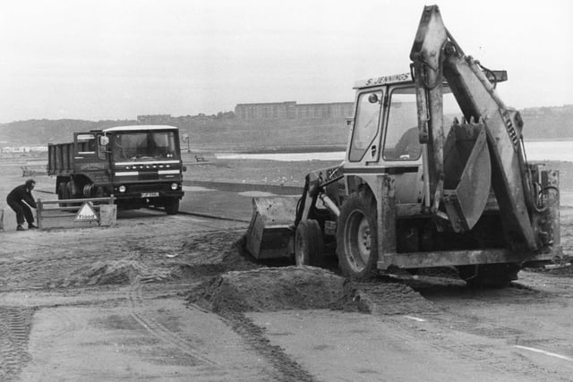 Workmen clear sand along the North Foreshore after a weekend of heavy storms in 1976. Remember this?