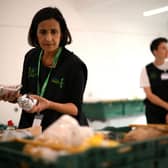 A member of staff sorts through food items inside a foodbank