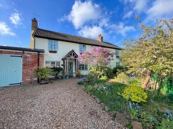 This enchanting cottage with established private gardens offers period features and spacious accommodation