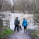 Walkers standing next to the River Ouzel when it overflowed in January. Photo: Phil Wood