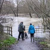Walkers standing next to the River Ouzel when it overflowed in January. Photo: Phil Wood