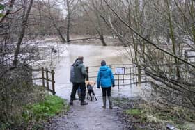 Walkers standing next to the River Ouzel when it overflowed in January. Photo: Phil Wood