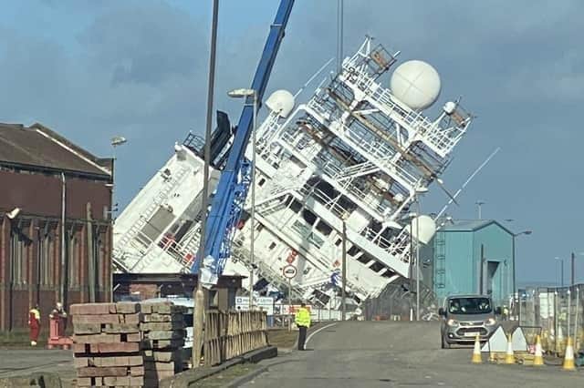 A ship is currently leaning towards the docks at a worrying angle in Leith, Edinburgh. Picture: @Tomafc83 on Twitter