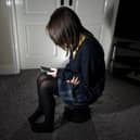 Photo of a young girl using a mobile phone. Picture; Peter Byrne/PA