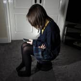 Photo of a young girl using a mobile phone. Picture; Peter Byrne/PA