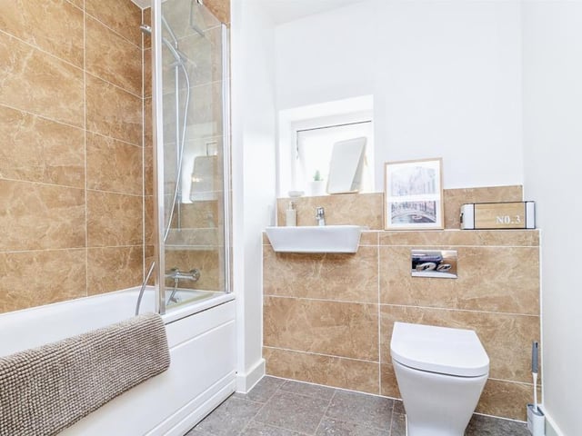 The family bathroom is fitted with bath with mixer taps and shower , wash hand basin, wc, extractor fan and radiator