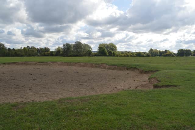 The large crater in this Woolstone field is still visible today