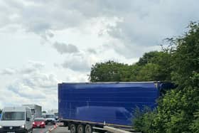 The lorry is stuck in trees on the M1 near Milton Keynes