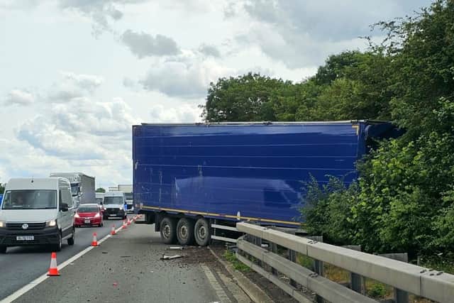The lorry is stuck in trees on the M1 near Milton Keynes