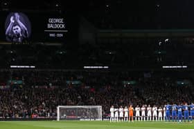 The players of England and Greece pause for a minutes' silence ahead of kick-off in honour of the passing of former MK Dons footballer George Baldock