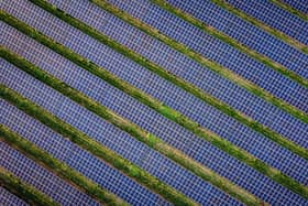 Library picture of a solar farm (Photo by Adrian DENNIS / AFP via Getty Images)