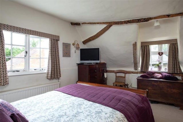 The double aspect main bedroom boasts exposed timbers in keeping with the character features found throughout the property