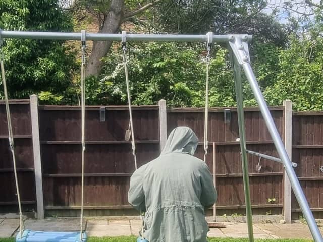 Emily in her garden at home. We have disguised her identity to keep her safe
