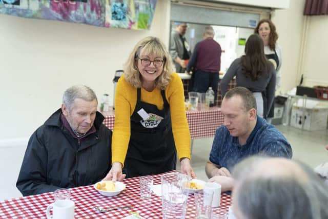 Volunteers serve hot food to diners at FoodCycle Milton Keynes Wolverton’s Community Meals session