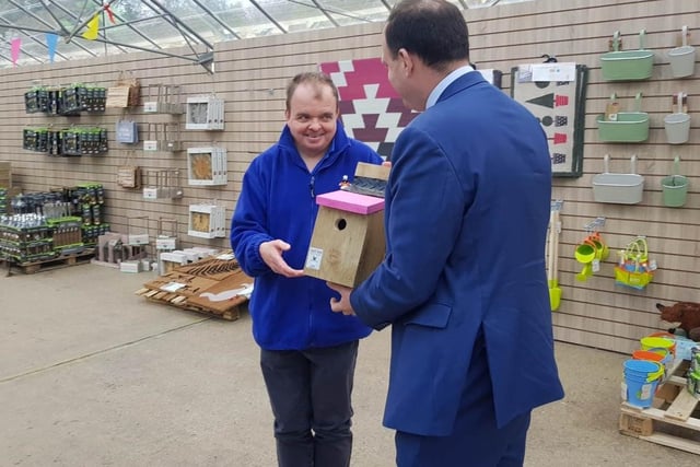 Greg Smith MP is presented with a handmade bird box by adult care client Jonathon