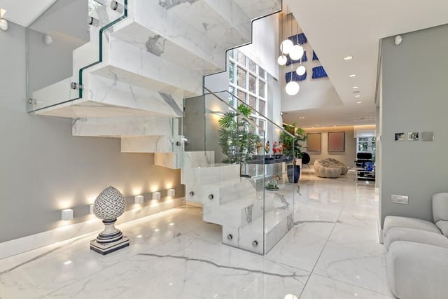 The spacious entrance hall leading featuring impressive marble effect Porcelanosa tiling that’s heated and stretches the entire ground floor accommodation