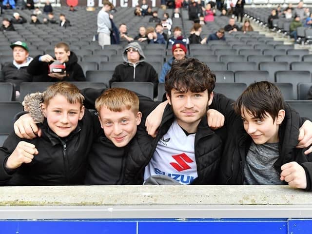 MK Dons fans have been praised by boss Paul Warne for staying with the team during a tough season.