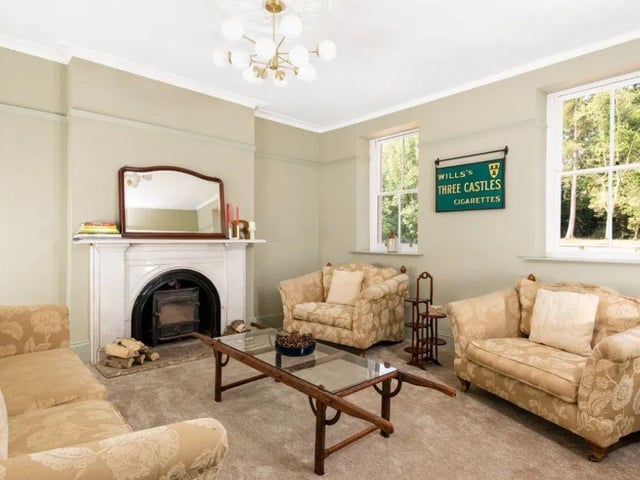 A bright living area features a cosy fireplace, perfect for year-round comfort. Photo: Fisher German LLP - South/ Zoopla
