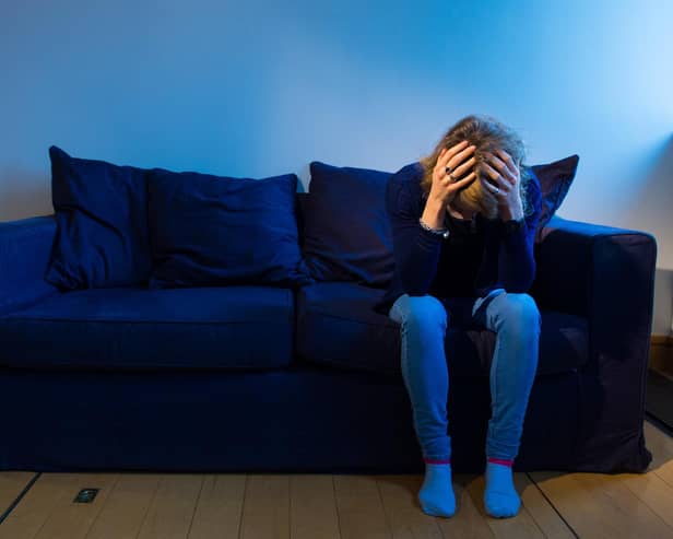 Woman with her head pin her hands. Picture: Dominic Lipinski/PA Wire