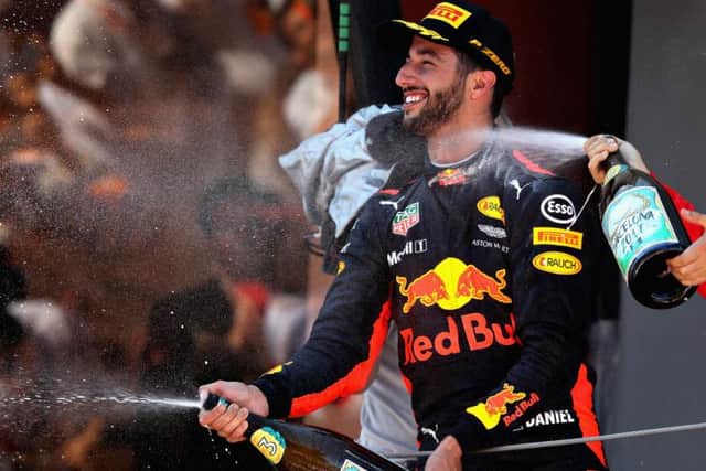 Daniel Ricciardo celebrates on the podium