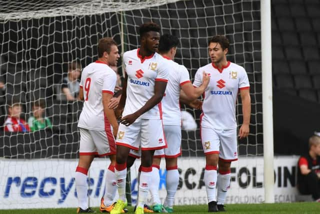 Dons celebrate Ryan Seager's opener against Brentford