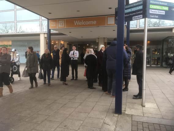 Shoppers wait outside after the building was evacuated. Picture by Jane Russell